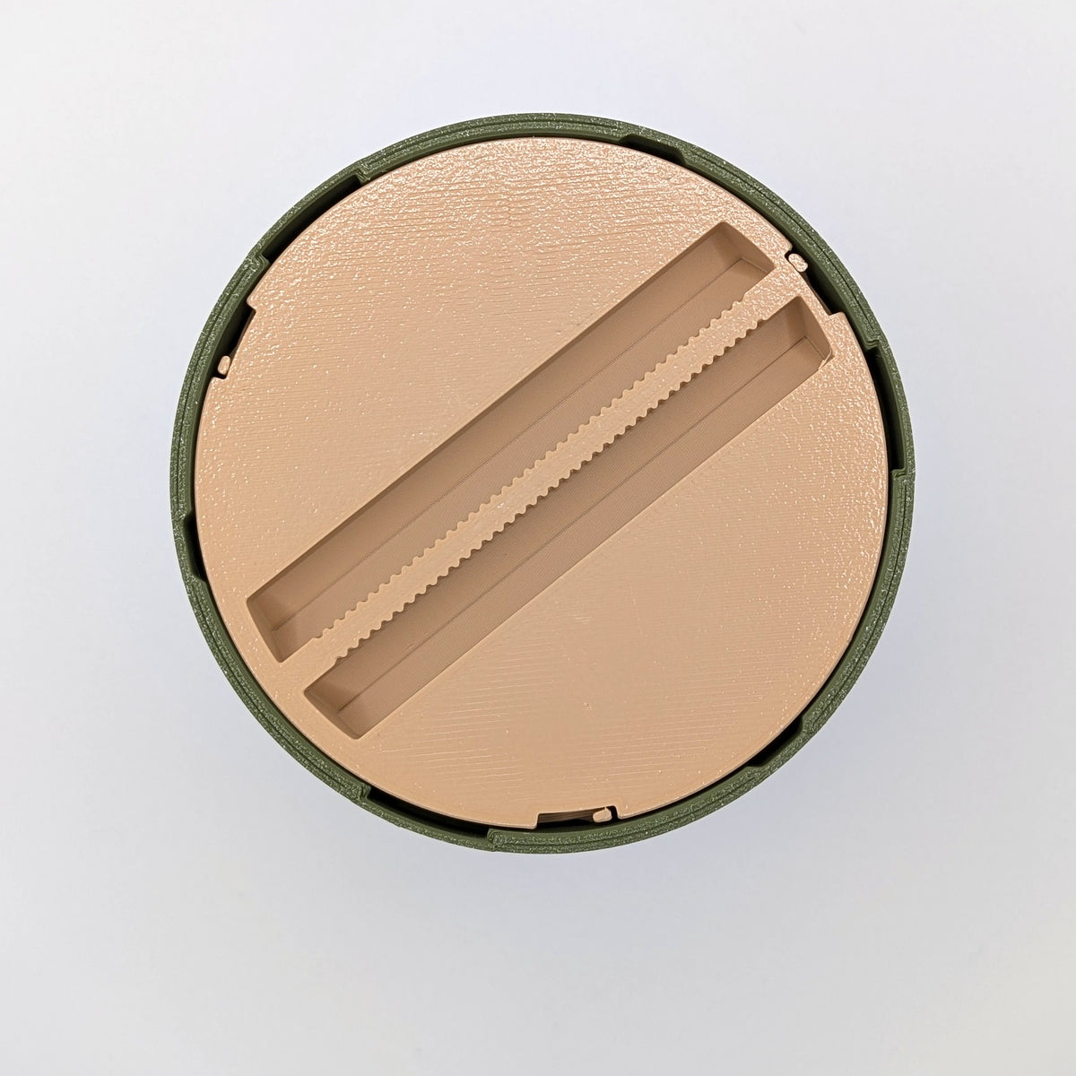 Underside of the tzedakah box, the ridged grip used to twist the cup out